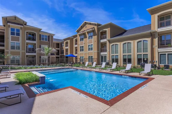 a view of a house with swimming pool and sitting area