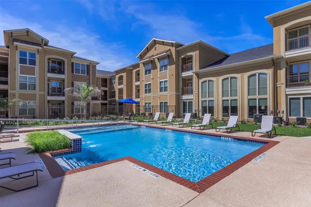 a view of a house with swimming pool and sitting area