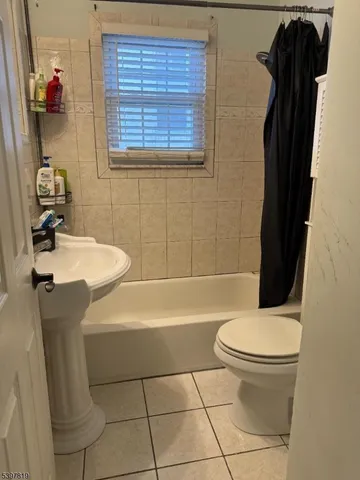 a bathroom with a sink a toilet and bathtub