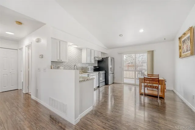 a view of kitchen with furniture and wooden floor