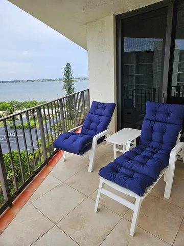 a view of two chairs in the balcony