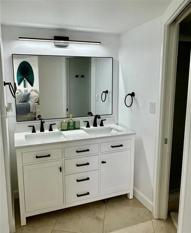 a bathroom with a double vanity sink and a mirror