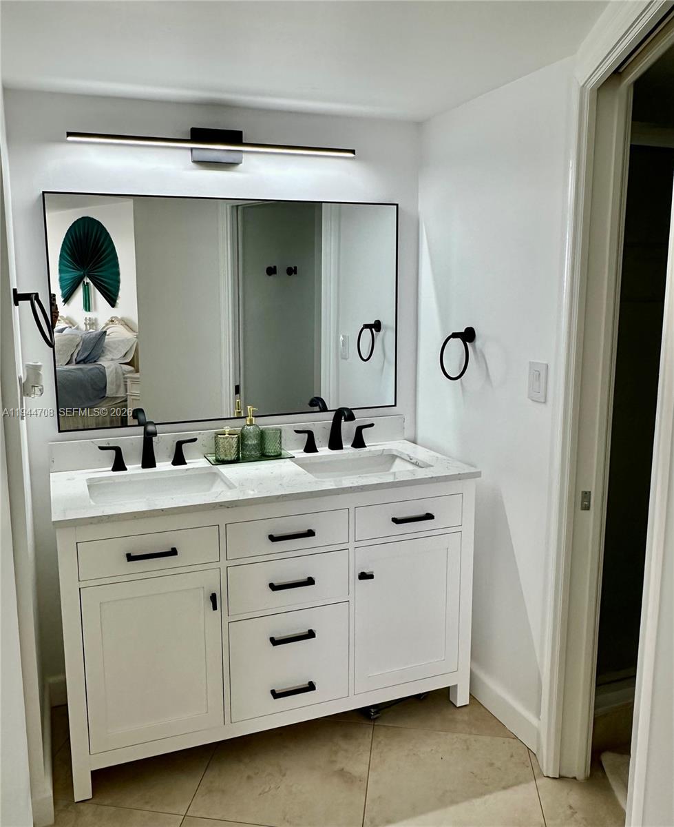 5420 North Ocean Drive, Unit 706 Singer Island, FL 33404 - Photo 20 of 41 a bathroom with a double vanity sink and a mirror