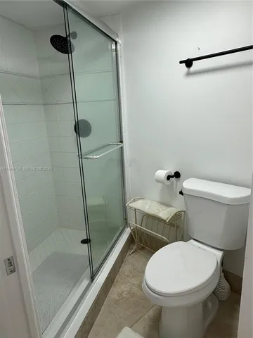 a bathroom with a toilet and a shower