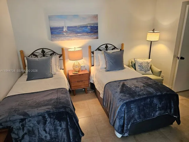 a bedroom with a bed and lamp