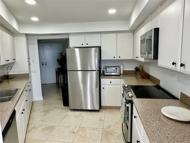 a kitchen with a refrigerator and a sink