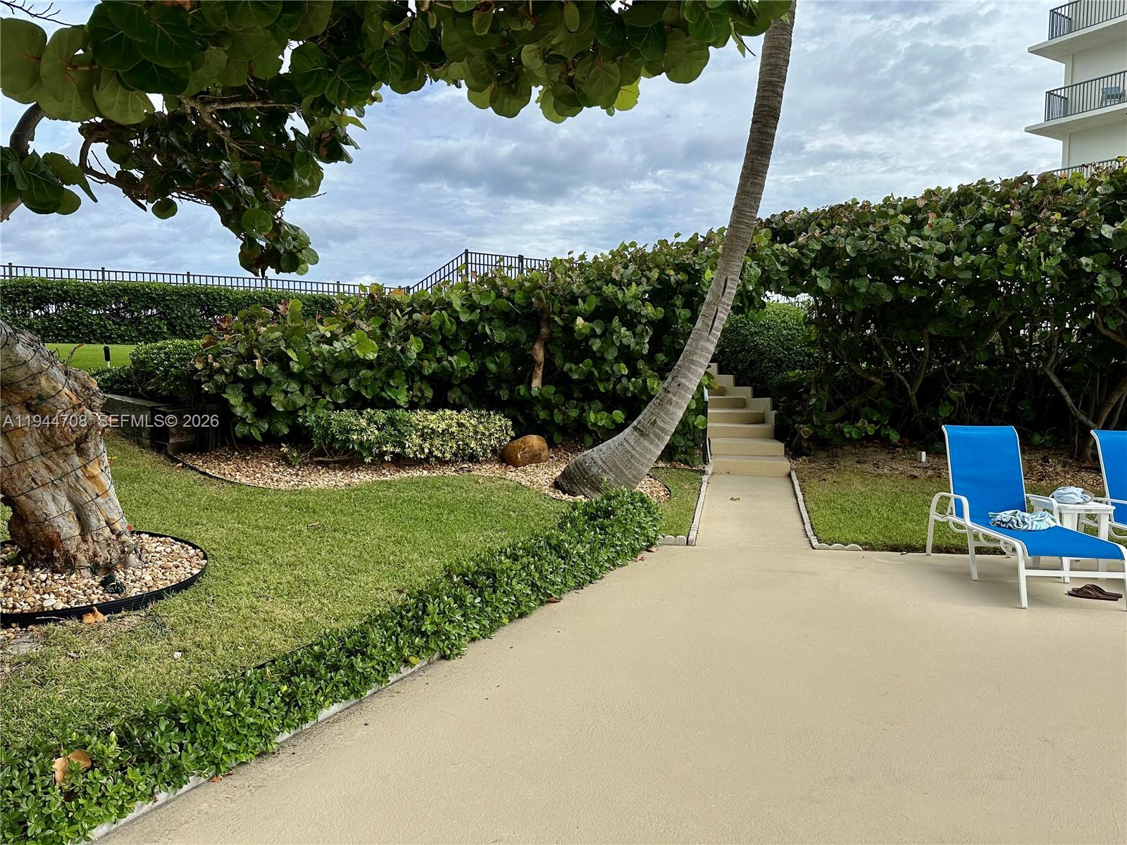 5420 North Ocean Drive, Unit 706 Singer Island, FL 33404 - Photo 33 of 41 a view of a park with plants and a bench