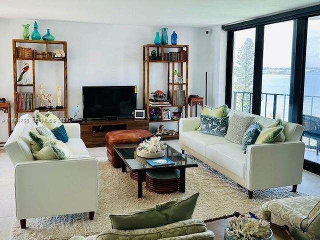 5420 North Ocean Drive, Unit 706 Singer Island, FL 33404 - Photo 4 of 41 a living room with furniture and a flat screen tv