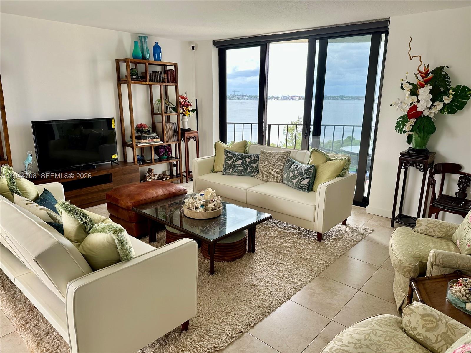 5420 North Ocean Drive, Unit 706 Singer Island, FL 33404 - Photo 10 of 41 a living room with furniture and a flat screen tv