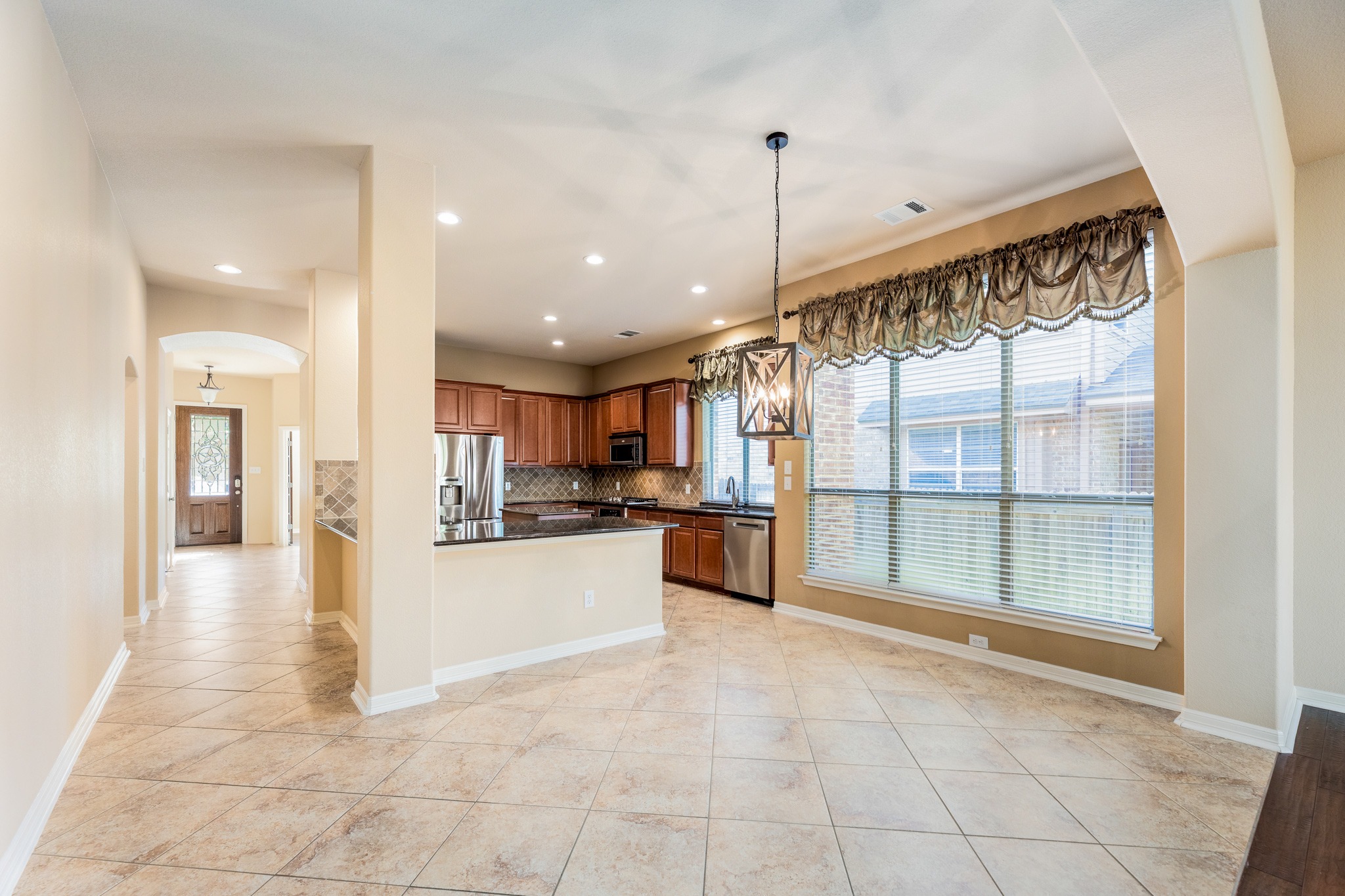 20804 Windmill Ridge Street Pflugerville, TX 78660 - Photo 15 of 40 The entry hallway flows past the formal dining room into the kitchen area and living room.