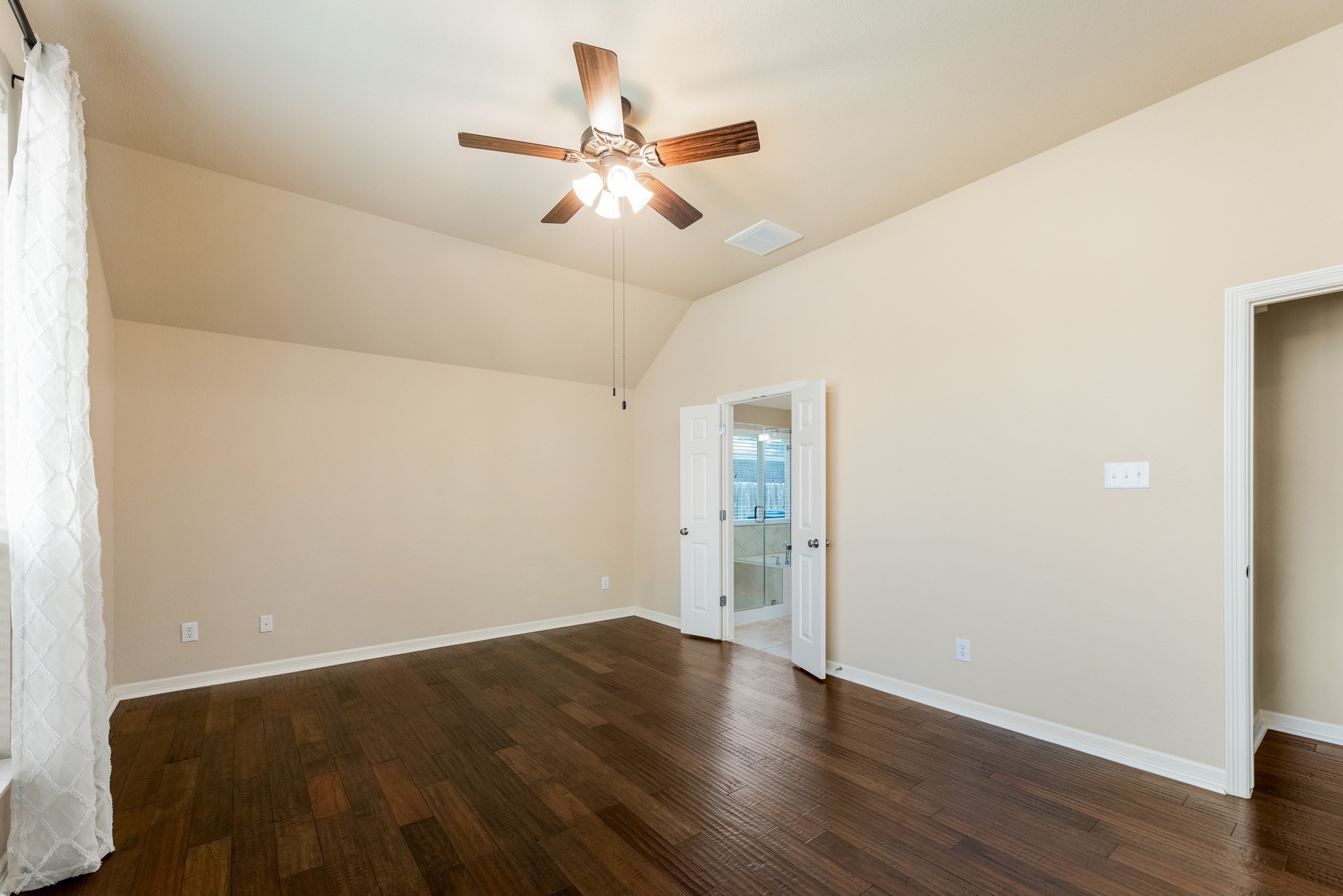 20804 Windmill Ridge Street Pflugerville, TX 78660 - Photo 19 of 40 Featuring tall ceilings, rich hardwoods, and ample space for a king sized bed, furniture and a seating area.