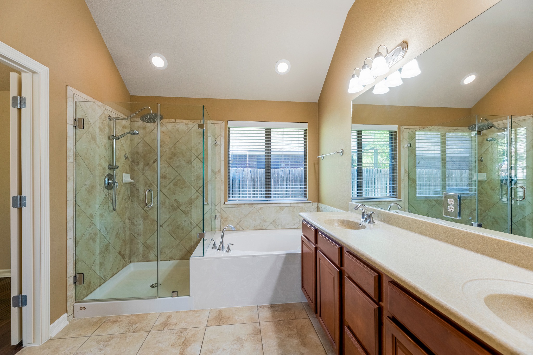 20804 Windmill Ridge Street Pflugerville, TX 78660 - Photo 22 of 40 Enjoy a relaxing built-in soaking tub and an updated frameless glass enclosed walk-in shower with tile surround.