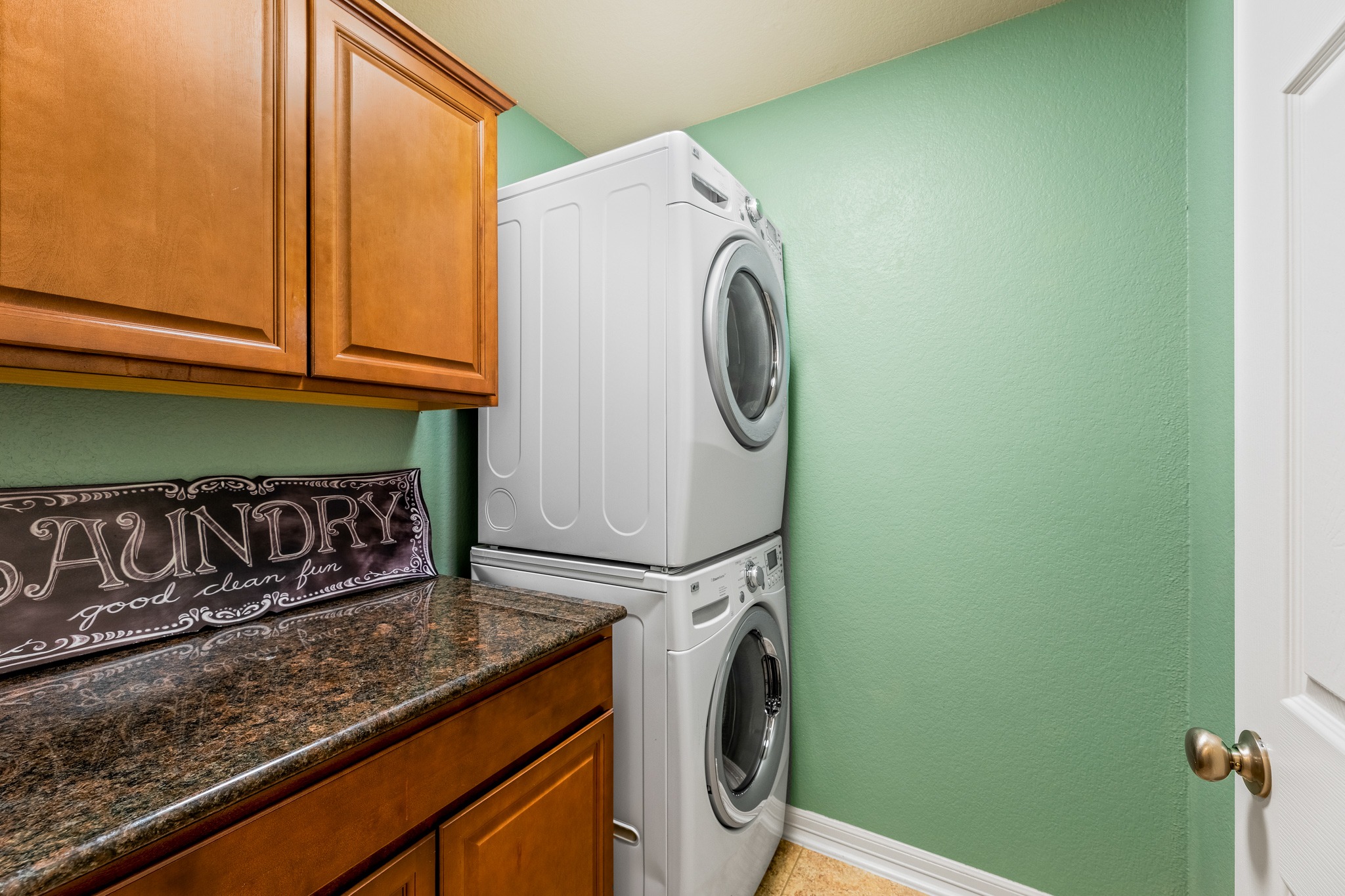 20804 Windmill Ridge Street Pflugerville, TX 78660 - Photo 33 of 40 The in home laundry room offers space for stackable washer & dryer alongside cabinetry storage and a folding vanity.