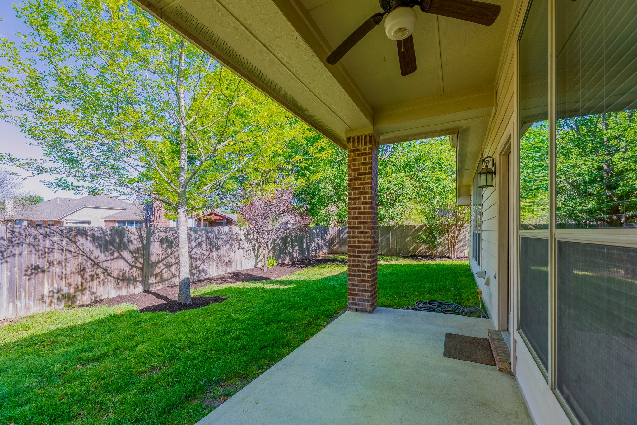 20804 Windmill Ridge Street Pflugerville, TX 78660 - Photo 34 of 40 Enjoy outdoor living on a spacious covered patio which overlooks a beautifully landscaped backyard.