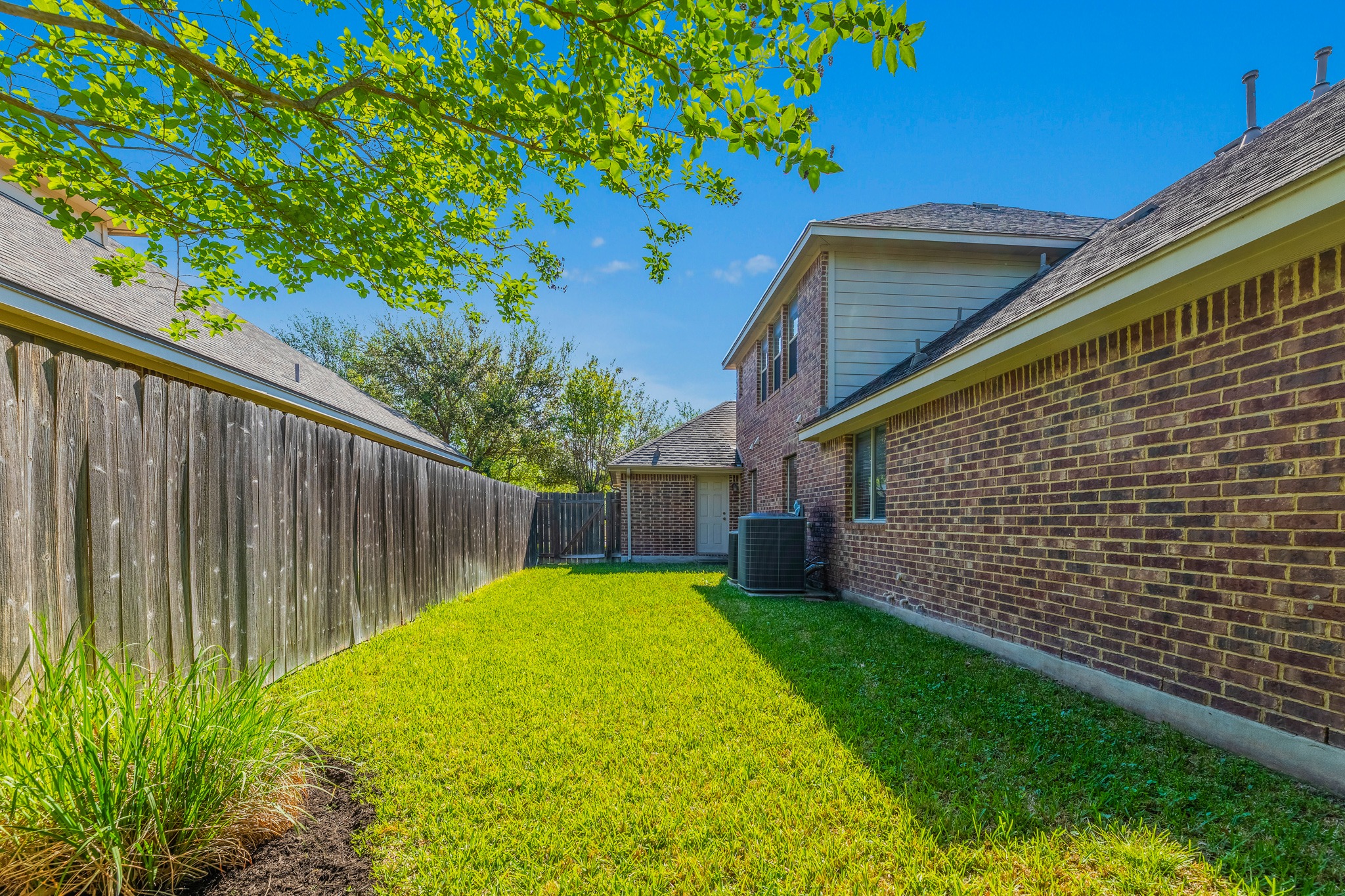 20804 Windmill Ridge Street Pflugerville, TX 78660 - Photo 39 of 40 Your backyard stretches along both sides of the home with garage access for easy mowing.