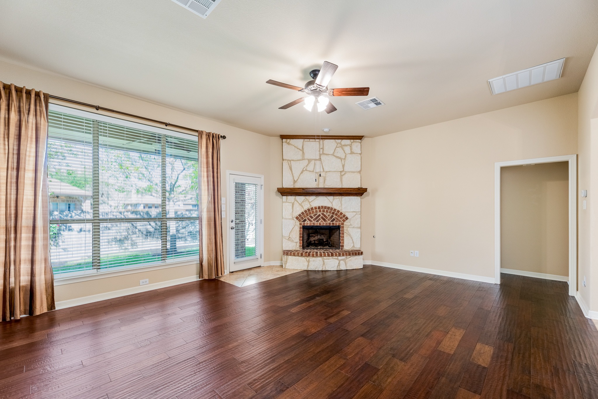 20804 Windmill Ridge Street Pflugerville, TX 78660 - Photo 7 of 40 Luminous living room with a large picture window framing backyard views and bringing in natural light.