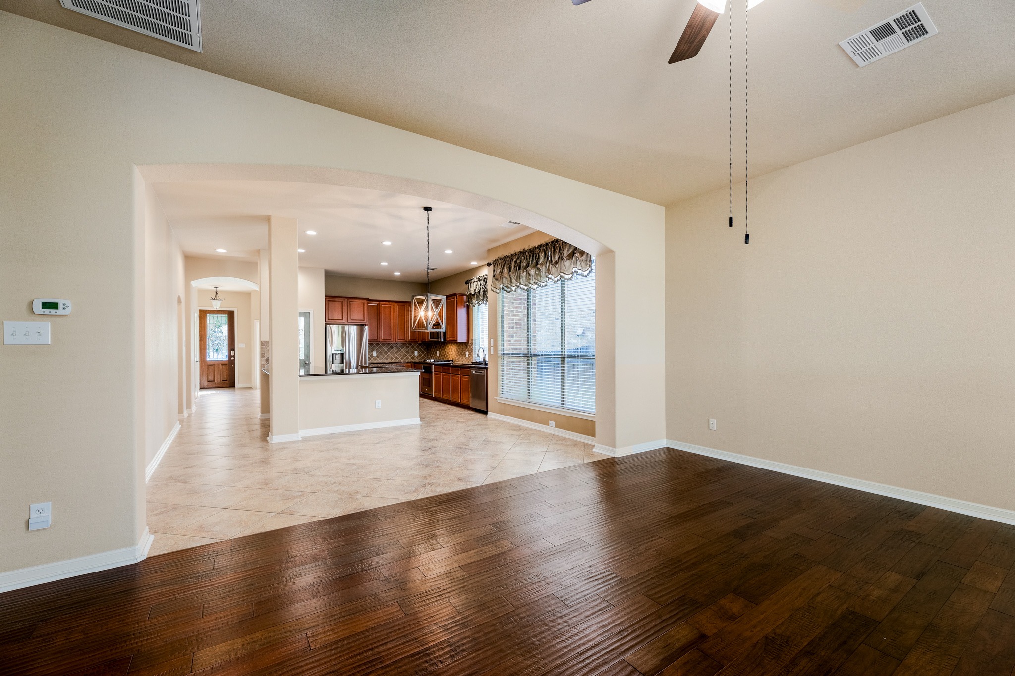 20804 Windmill Ridge Street Pflugerville, TX 78660 - Photo 9 of 40 The main living area flows into a bright and spacious kitchen and dining area with a sweeping archway above.
