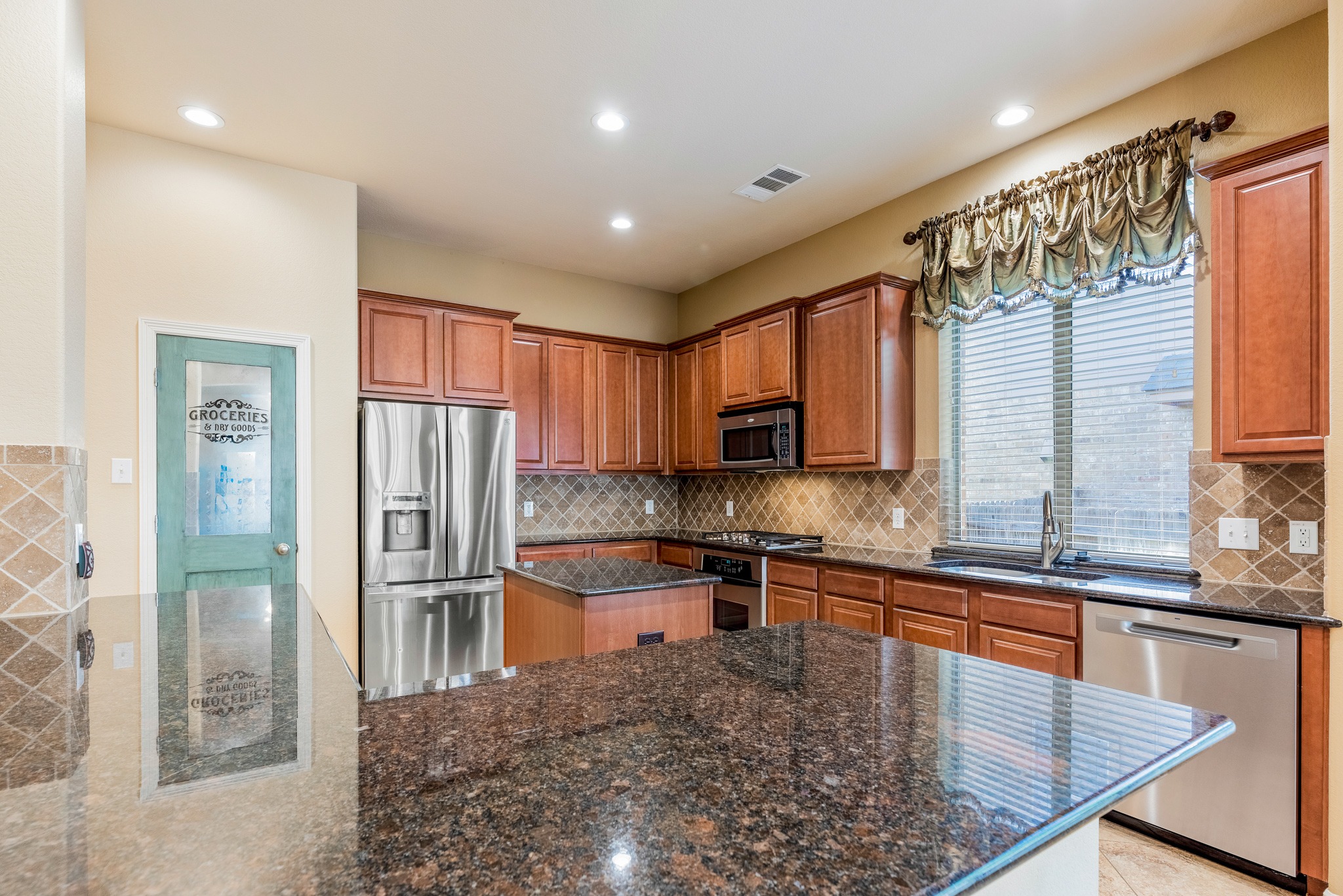 20804 Windmill Ridge Street Pflugerville, TX 78660 - Photo 10 of 40 The kitchen is the gathering hub of the home with a wrap around peninsula overlooking the sunny dining area.