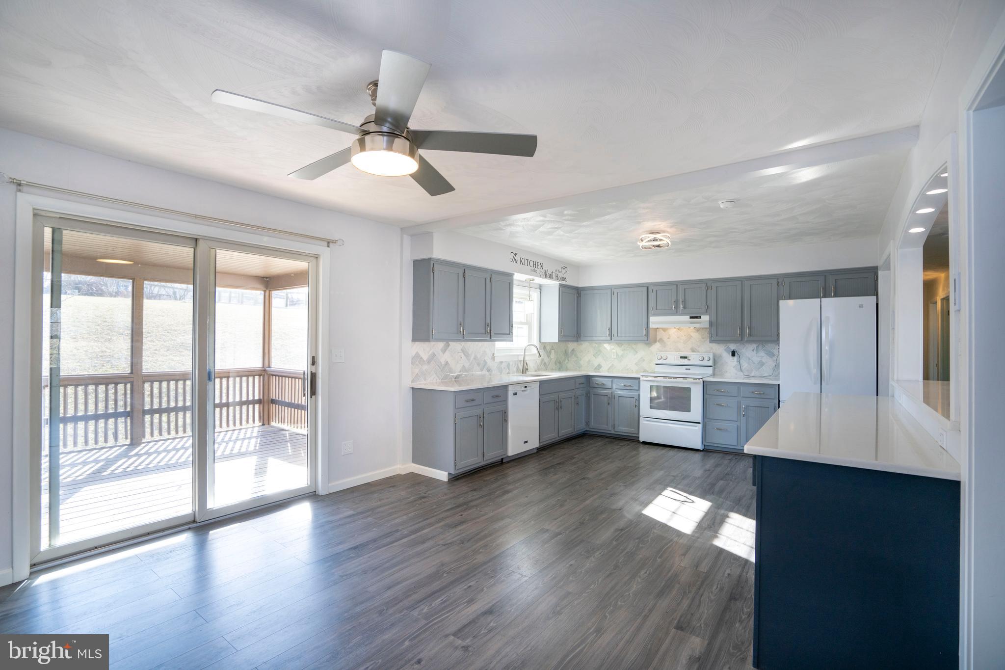 2510 Buchenhorst Road State College, PA 16801 - Photo 25 of 64 a large white kitchen with a large window a sink and stainless steel appliances