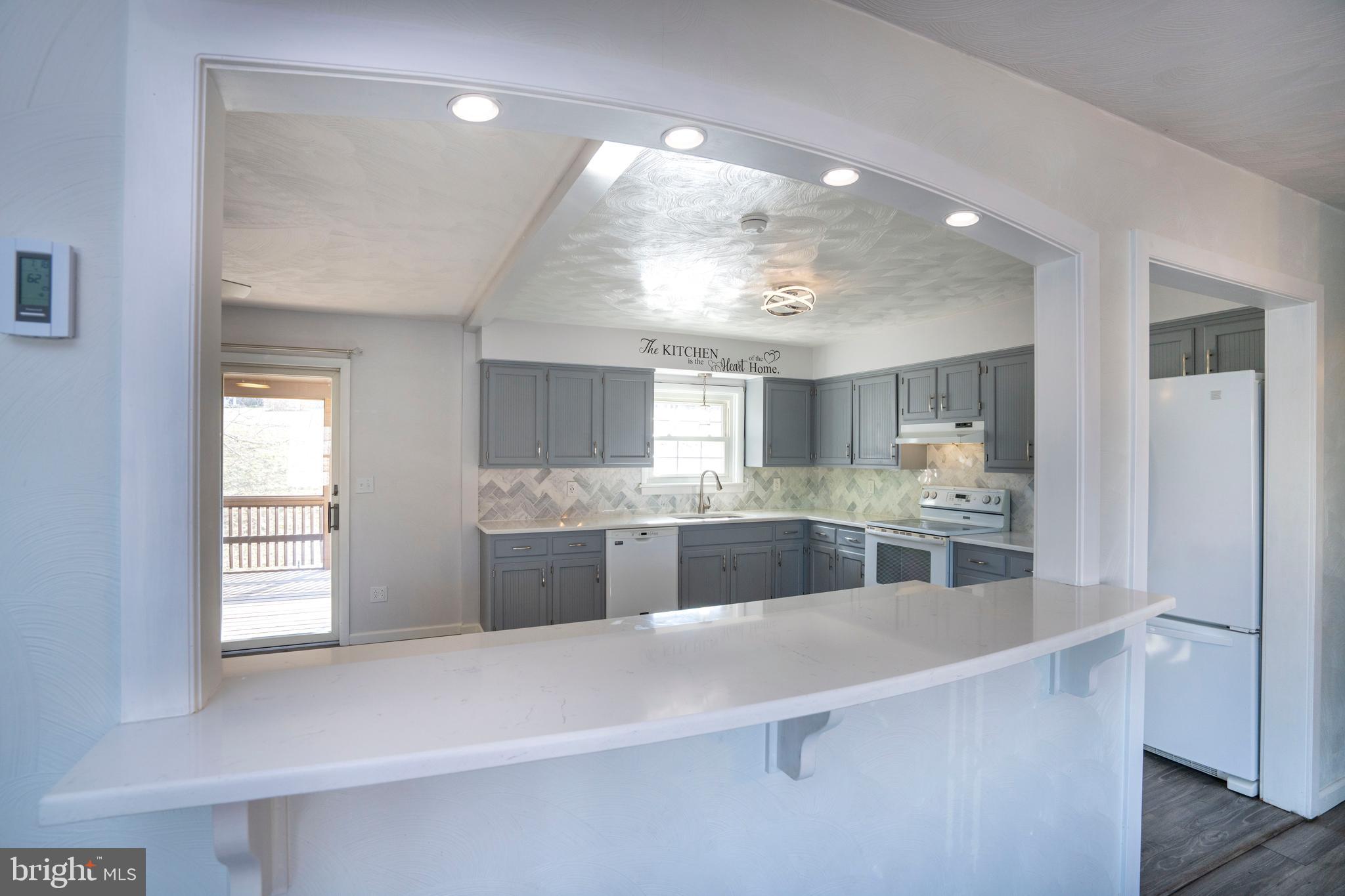 2510 Buchenhorst Road State College, PA 16801 - Photo 36 of 64 a large kitchen with kitchen island a large counter top appliances and cabinets
