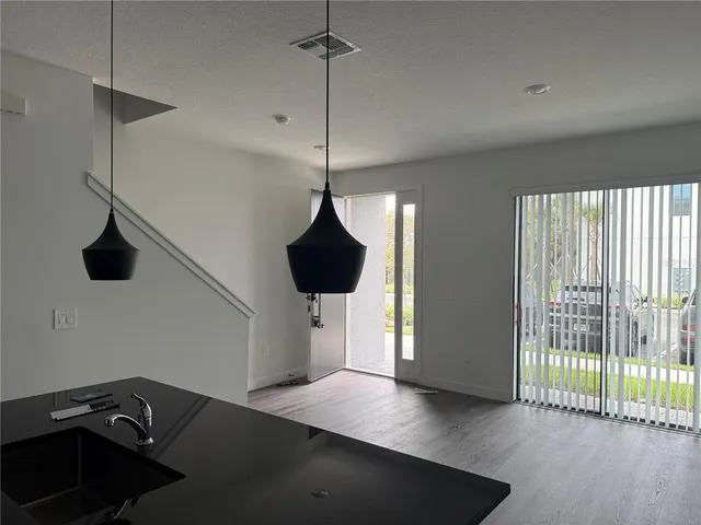 a view of a room with a ceiling fan and a wooden floor