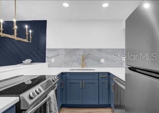 a kitchen with a sink stove and cabinets