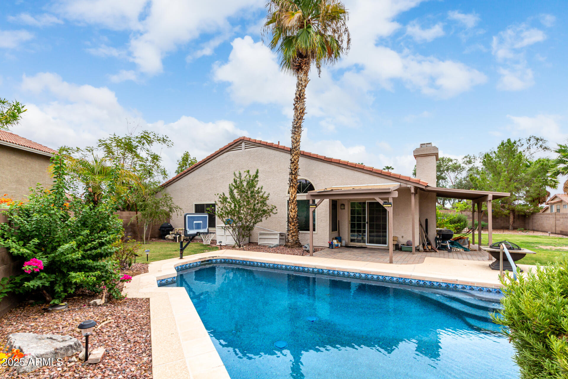 a view of a house with swimming pool and porch with furniture