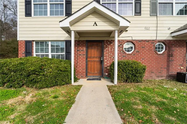 a front view of a house with a garden and plants
