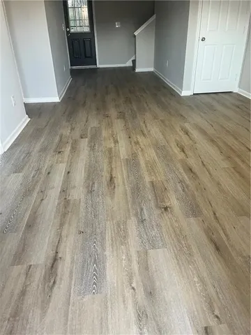 a view of a room with wooden floor
