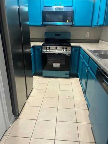 a kitchen with a stove a refrigerator and a counter top
