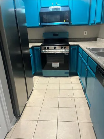 a kitchen with a stove a microwave and a sink