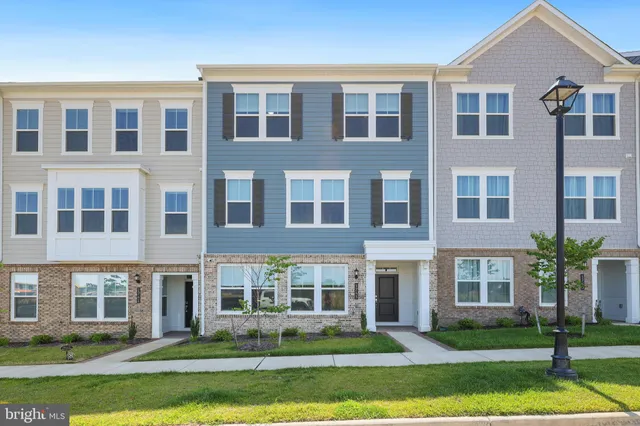 front view of a brick building with a yard