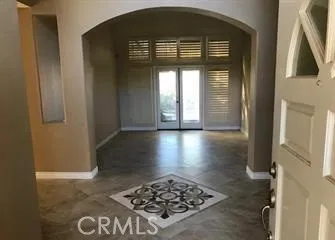 a view of a hallway to a livingroom with furniture