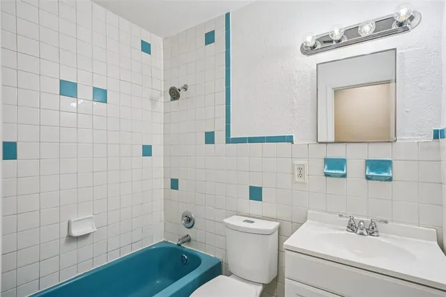 a bathroom with a sink mirror toilet and bathtub