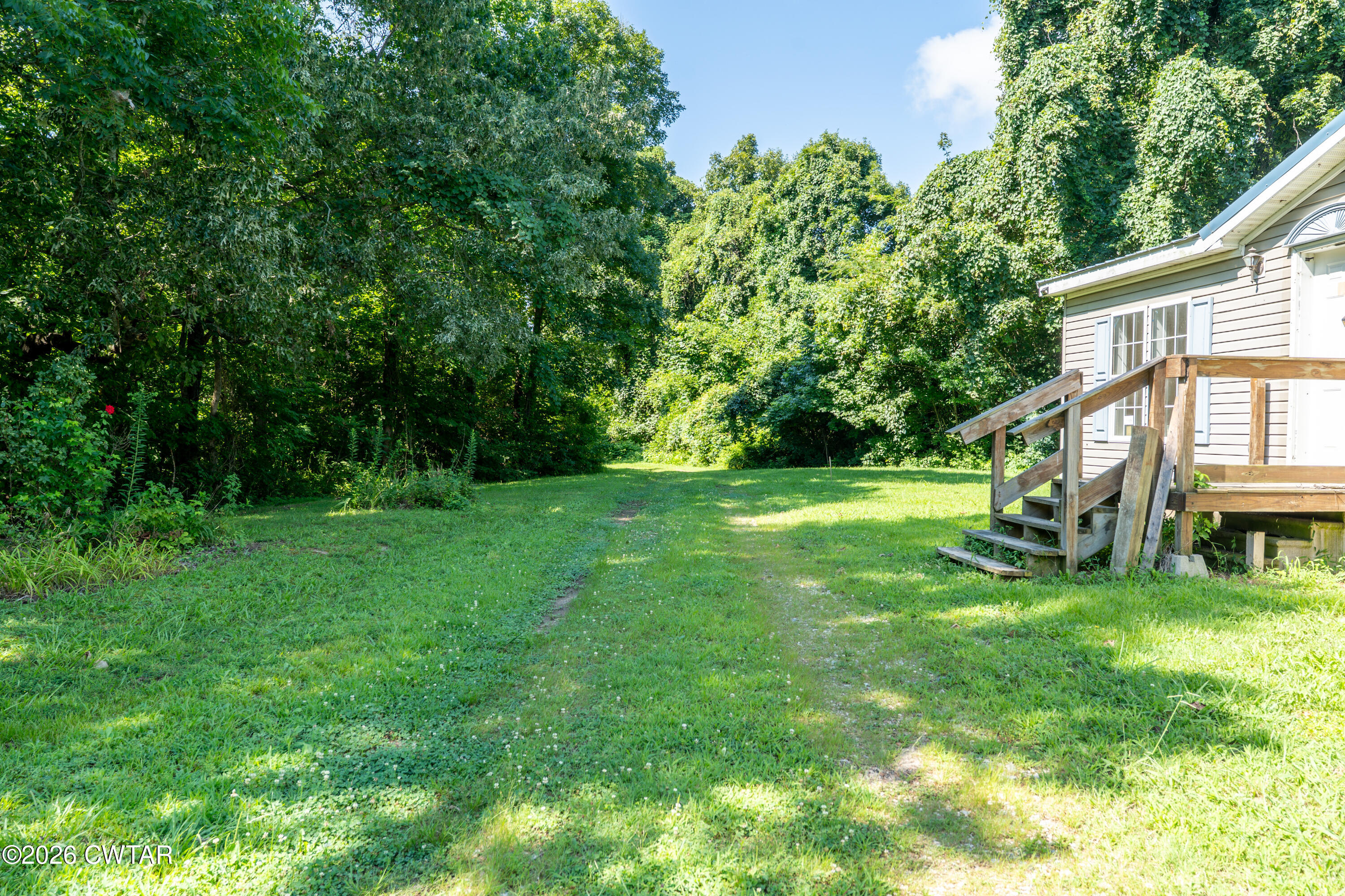 3454 Treece Road Hornbeak, TN 38232 - Photo 6 of 25 a view of a house with a backyard