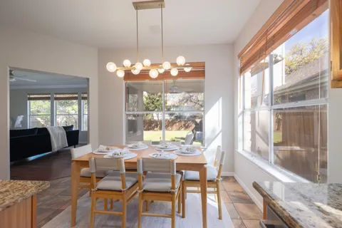 a view of a dining room with furniture wooden floor and chandelier