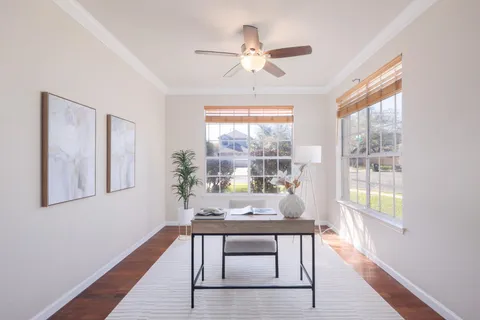 a view of a livingroom with furniture window and wooden floor