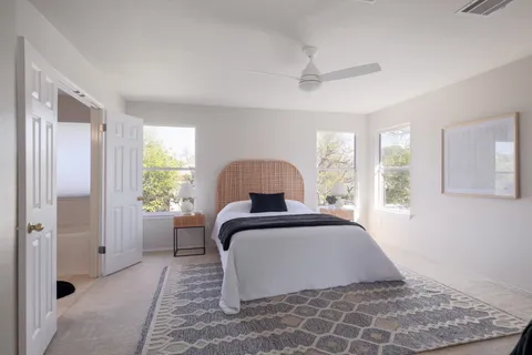 a bedroom with a bed and a window