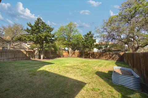 a view of a yard with basketball court