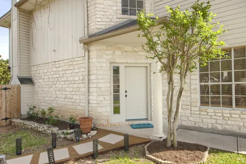 a front view of a house with outdoor seating