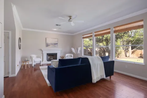 a living room with furniture fireplace and window