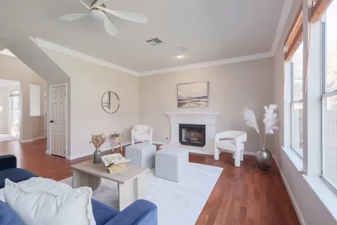a living room with furniture a fireplace and a window