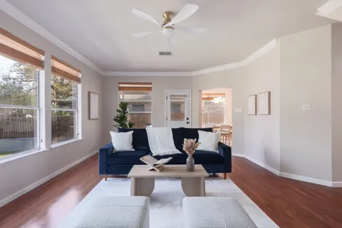a living room with furniture and wooden floor