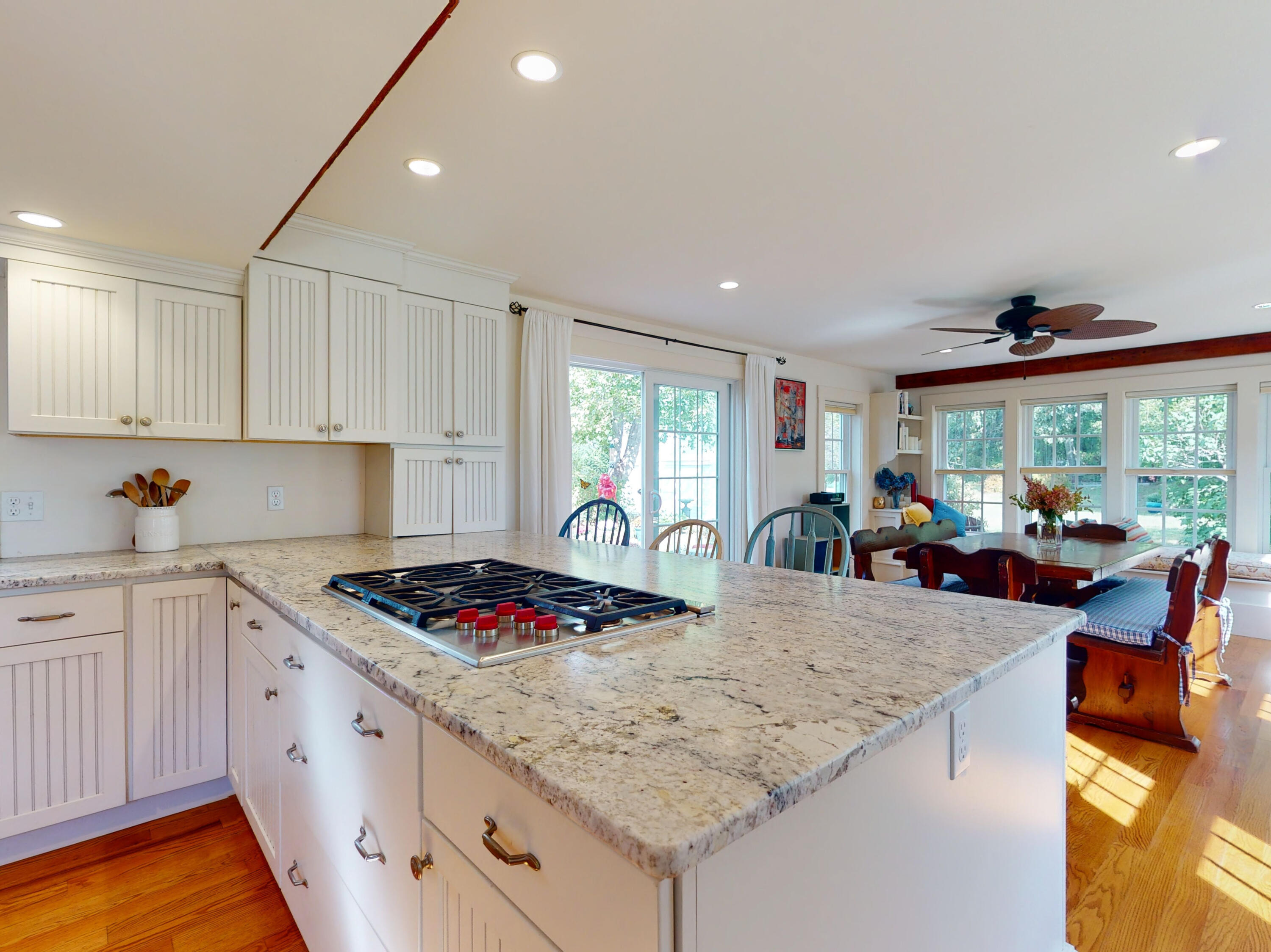 280 Chatham Road Harwich, MA 02645 - Photo 15 of 45 a kitchen with sink stove and white cabinets with wooden floor