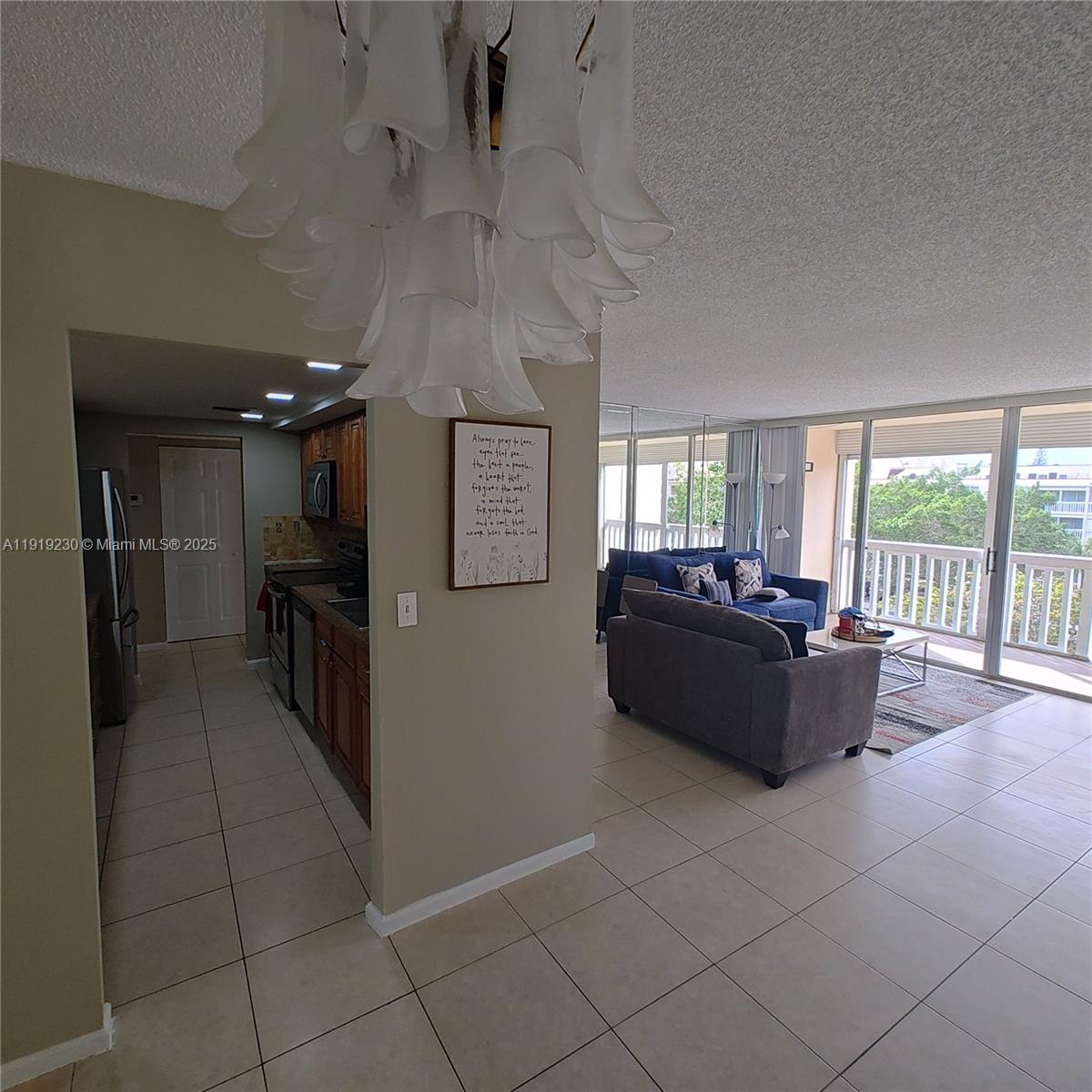 7051 Environ Boulevard, Unit 433 Lauderhill, FL 33319 - Photo 11 of 36 a living room with hard wood flooring and a couch