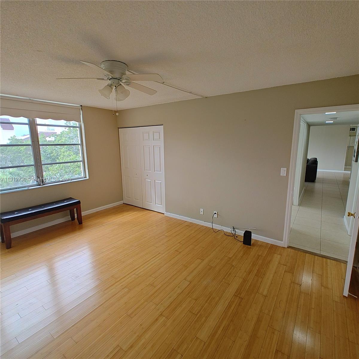 7051 Environ Boulevard, Unit 433 Lauderhill, FL 33319 - Photo 14 of 36 an empty room with wooden floor and windows