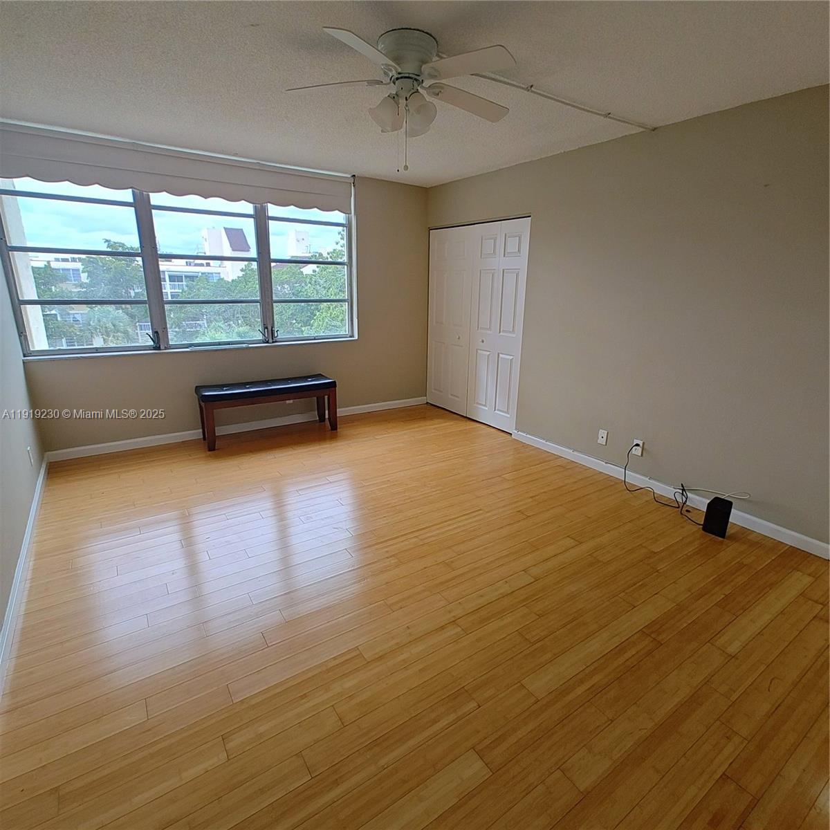 7051 Environ Boulevard, Unit 433 Lauderhill, FL 33319 - Photo 15 of 36 a view of an empty room with wooden floor and a window