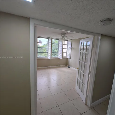 a view of an empty room with glass door