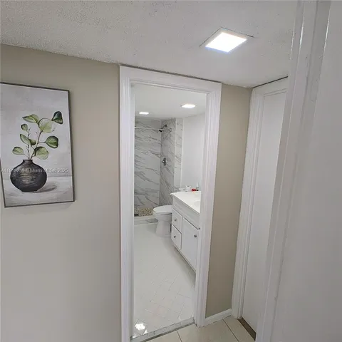 a bathroom with a double vanity sink toilet and shower