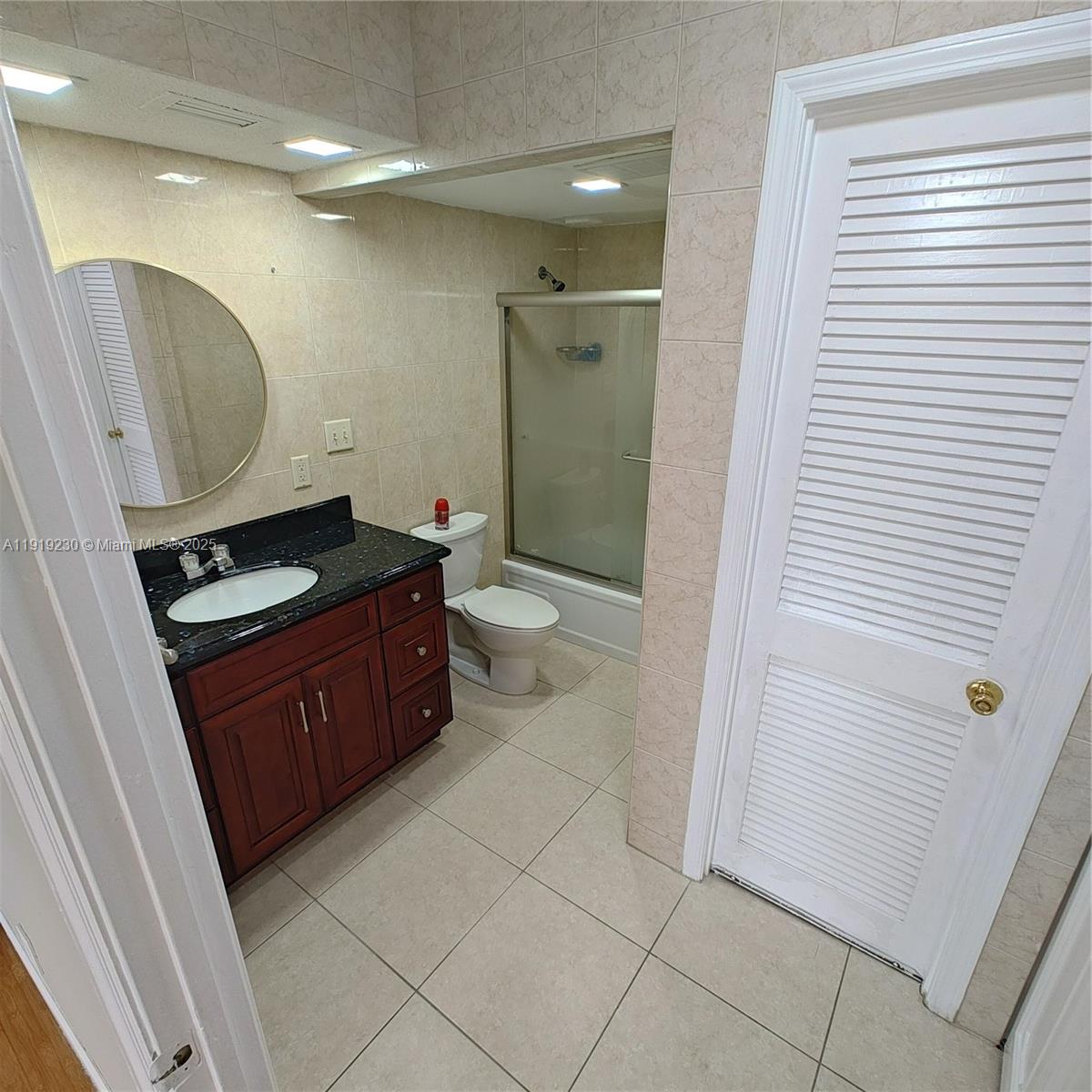 7051 Environ Boulevard, Unit 433 Lauderhill, FL 33319 - Photo 29 of 36 a bathroom with a sink a toilet and shower